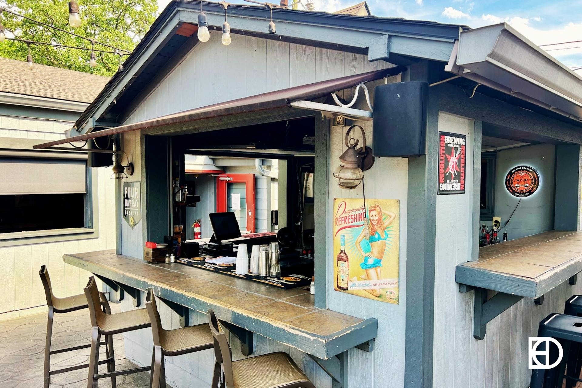 Outdoor photo of patio seating and bar at Flatwater