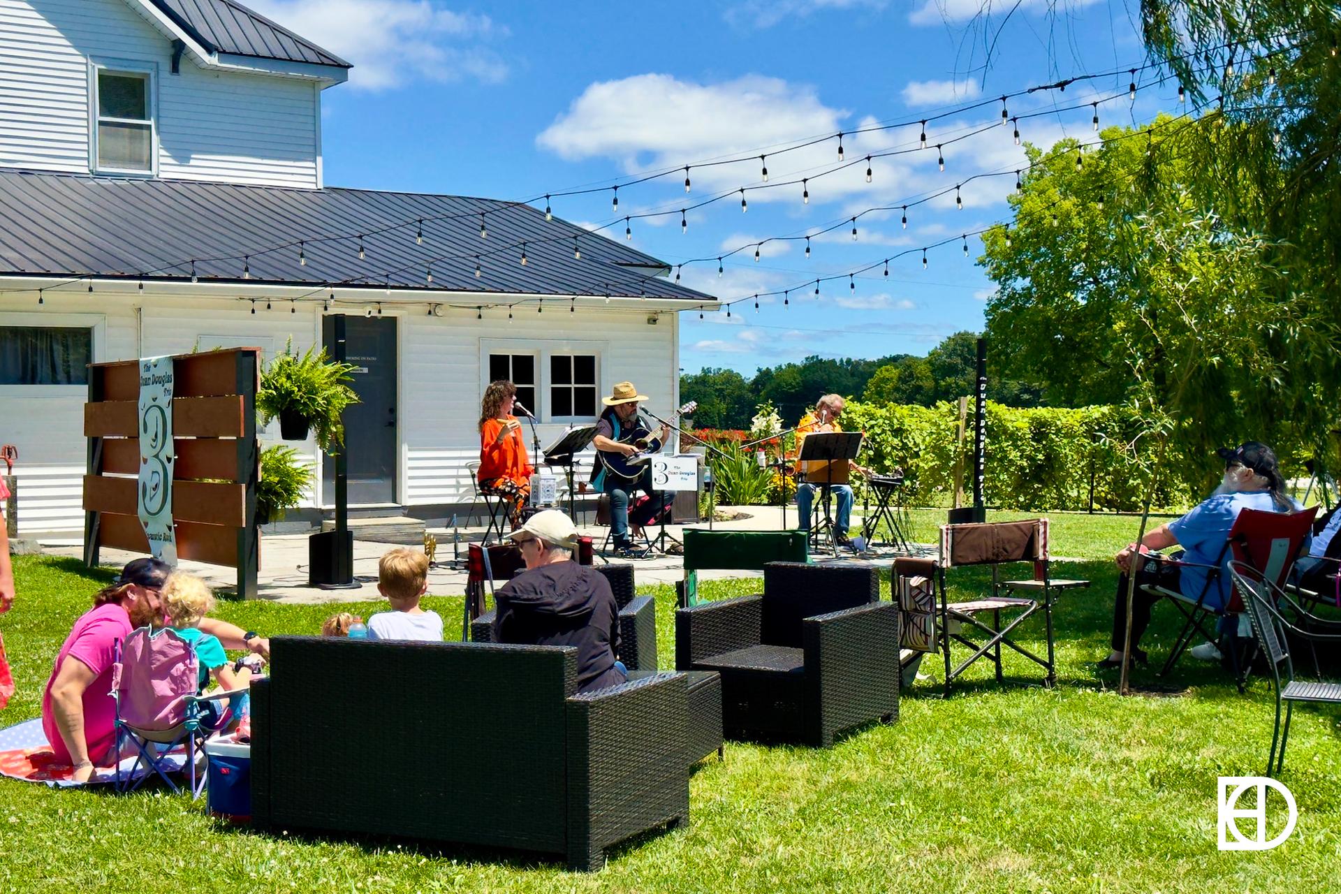 Exterior photo of Spencer Farm Winery, showing farmhouse and patio