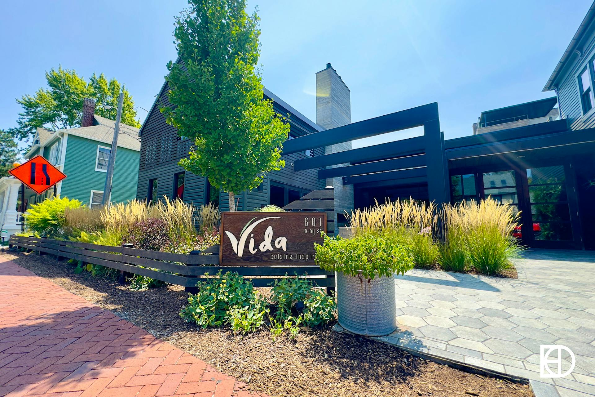 Exterior photo of Vida, showing patio and signage