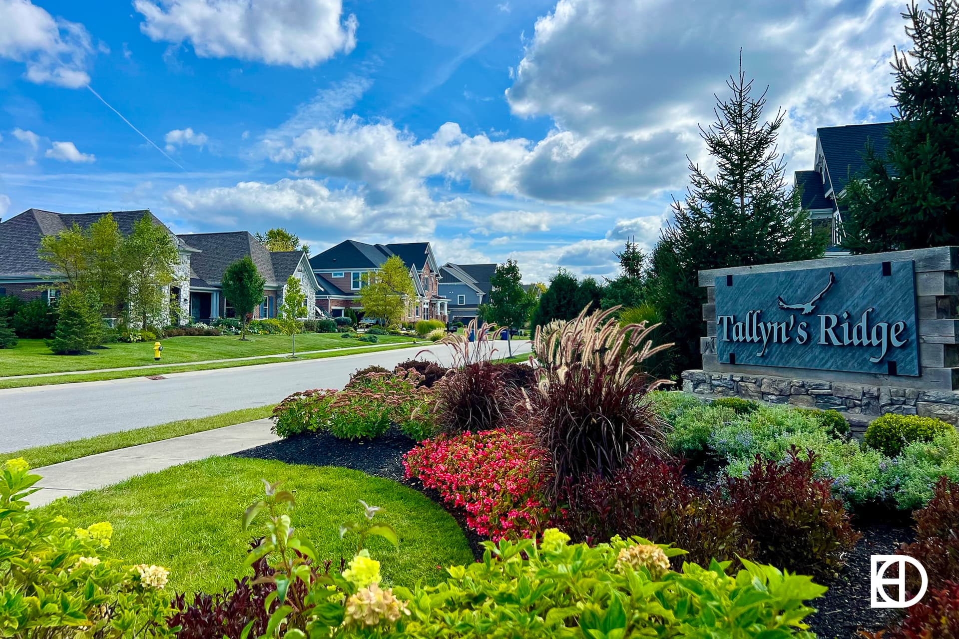 Exterior photo of Tallyn's Ridge, showing signage, homes, and landscaping