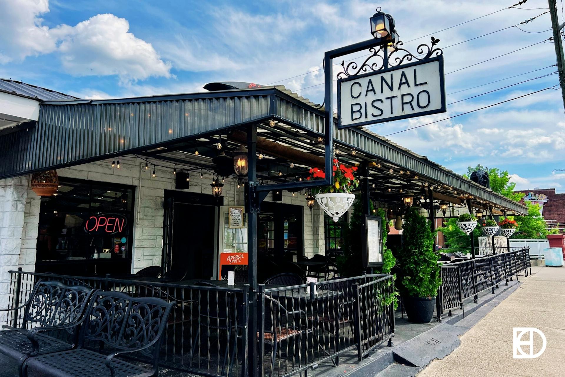 Outdoor photo of patio seating and signage at Canal Bistro