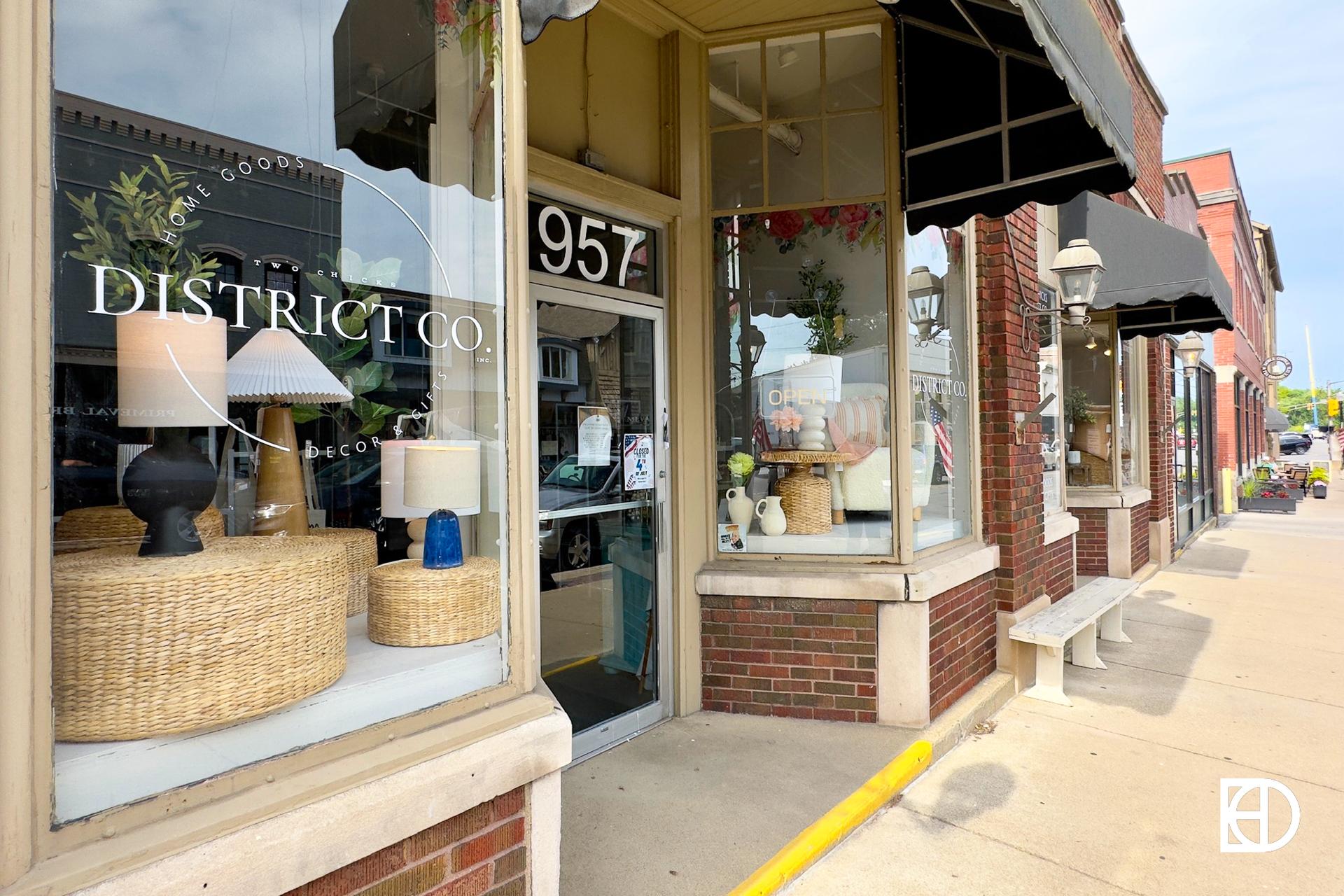 Exterior photo of Two Chicks District Co., showing entrance and signage