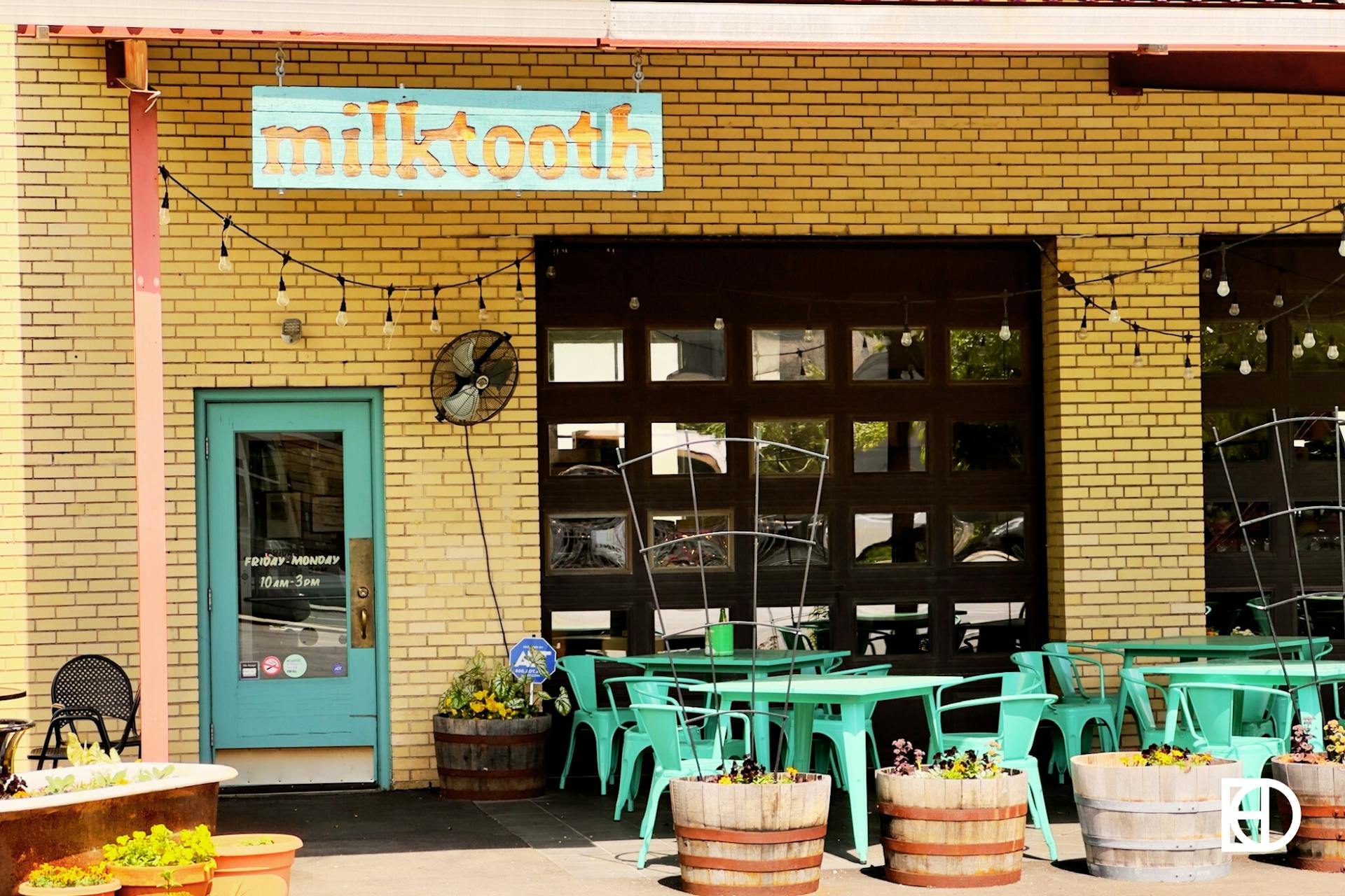 Exterior photo of Milktooth, showing patio and entrance