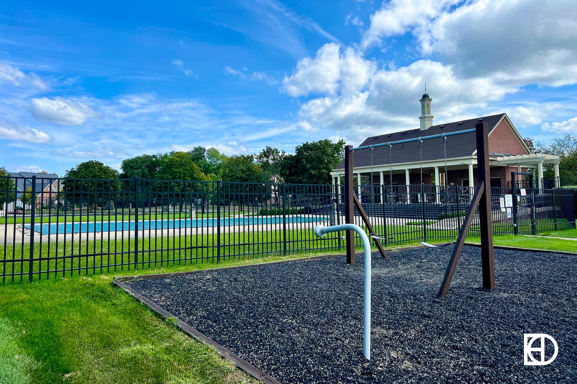 Exterior photo of Kingsborough, showing playground and pool