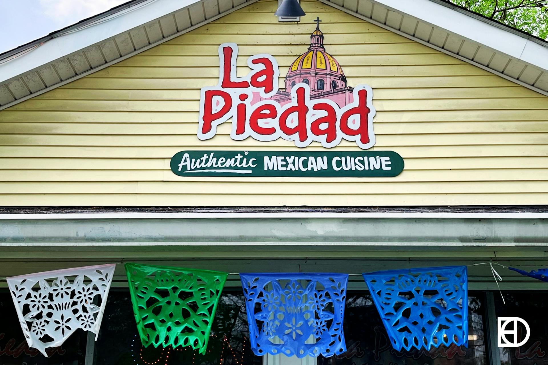 Exterior photo of La Piedad, showing signage