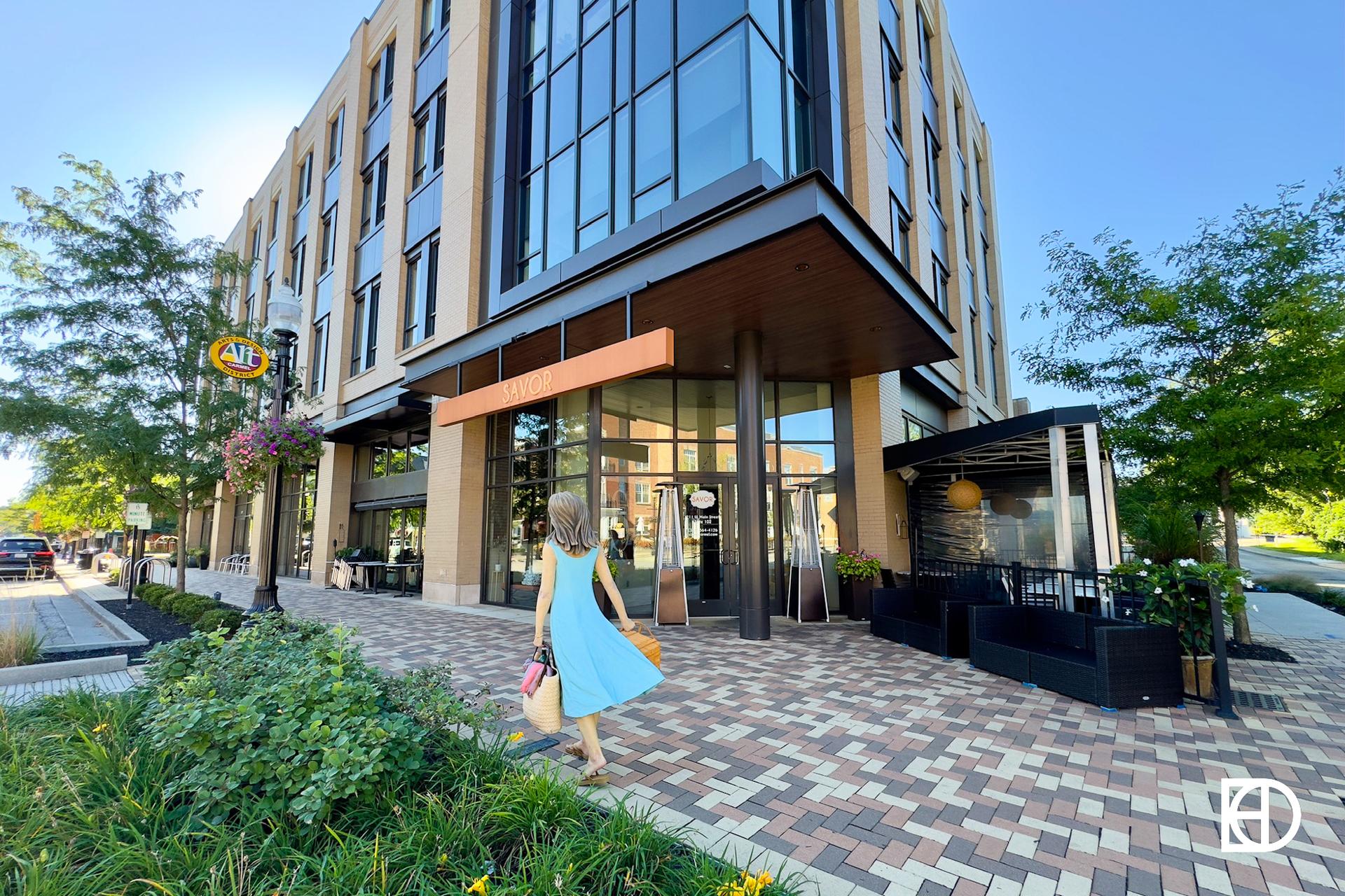 Exterior photo of Savor Restaurant, showing statute and entrance