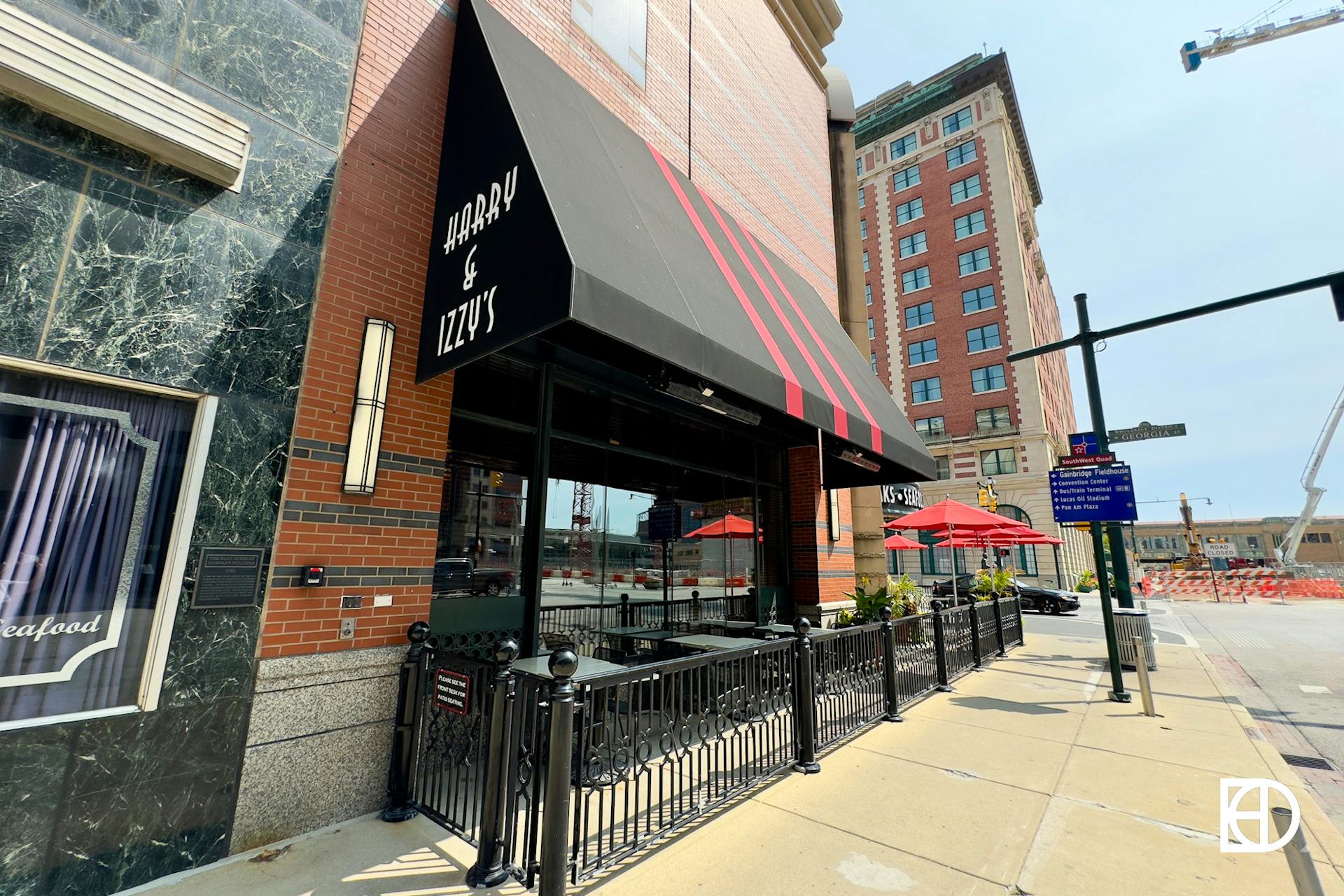 Exterior photo of Harry & Izzy's, showing signage and patio