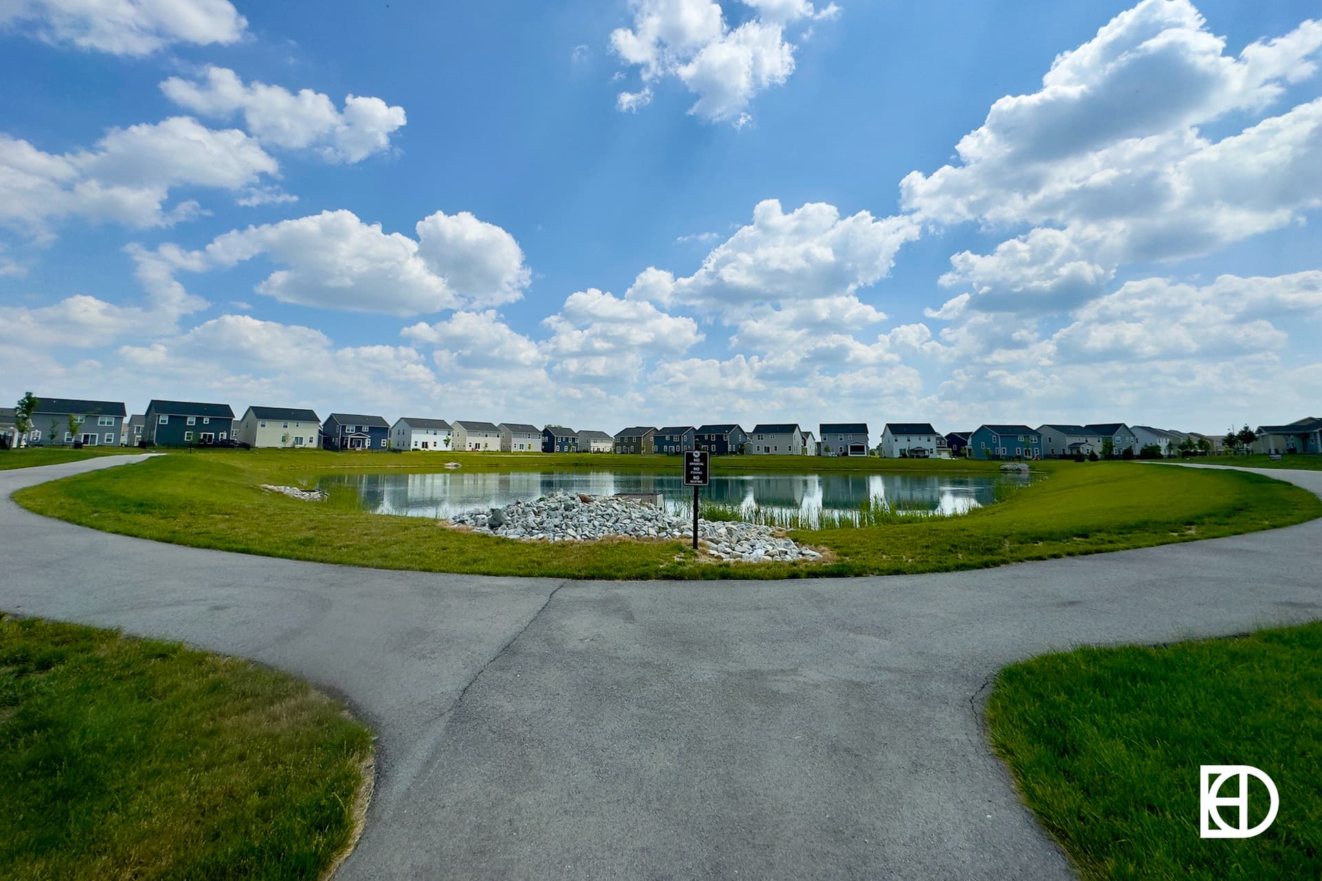 Photo of walking path surrounding pond in Gristmill Trails.