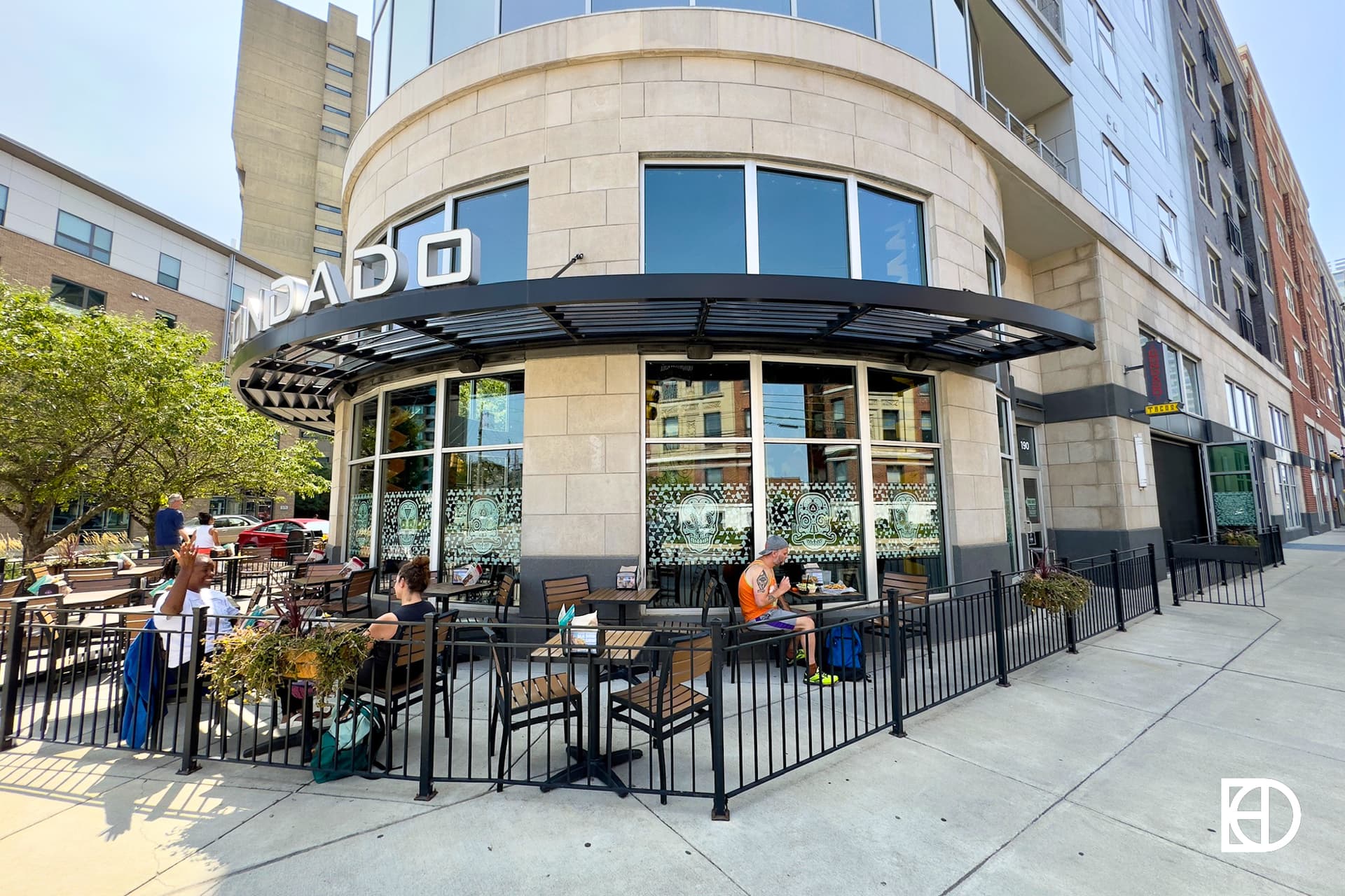 Exterior photo of Condado Tacos, showing patio and signage