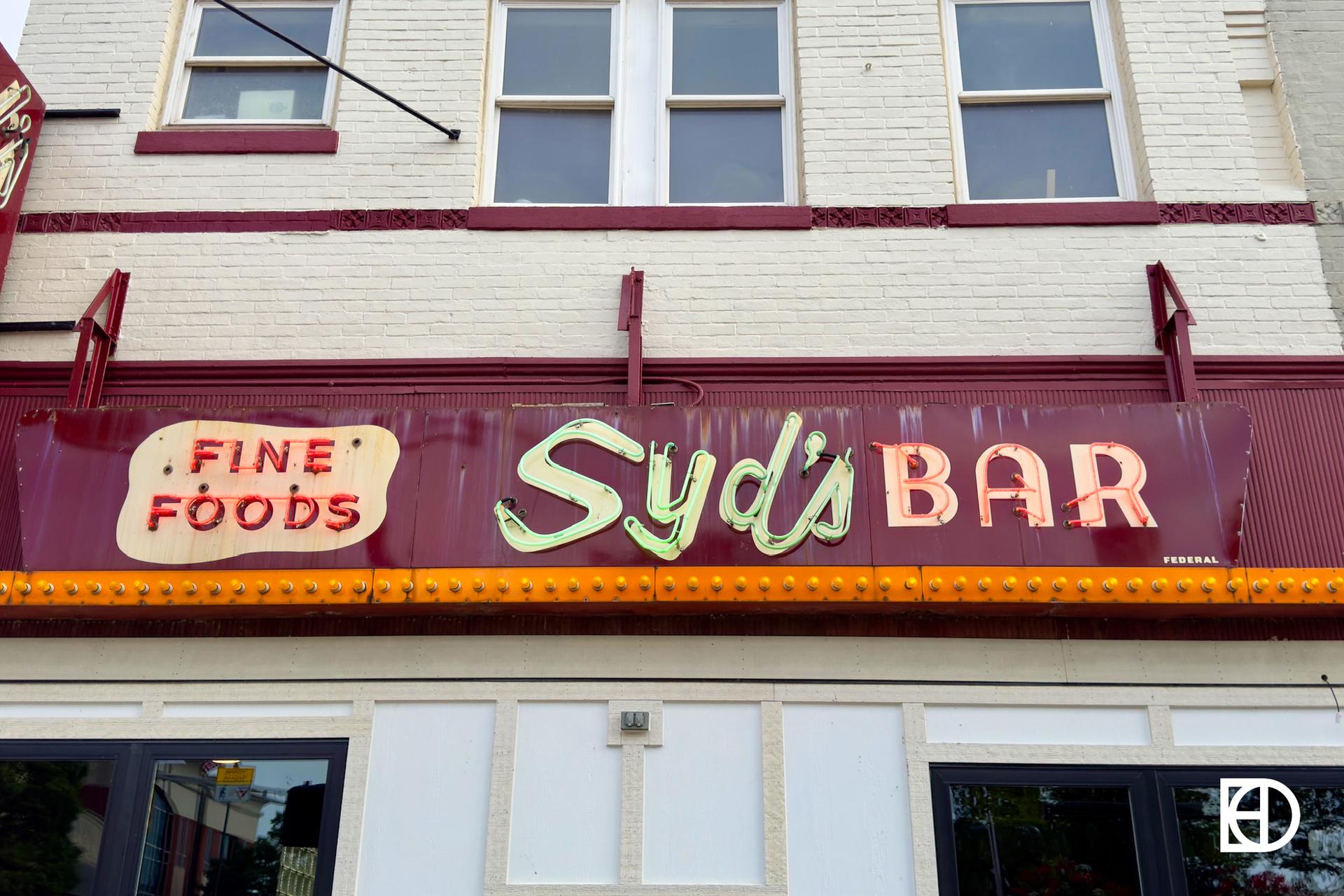 Exterior photo of Syd's, showing signage and entrance