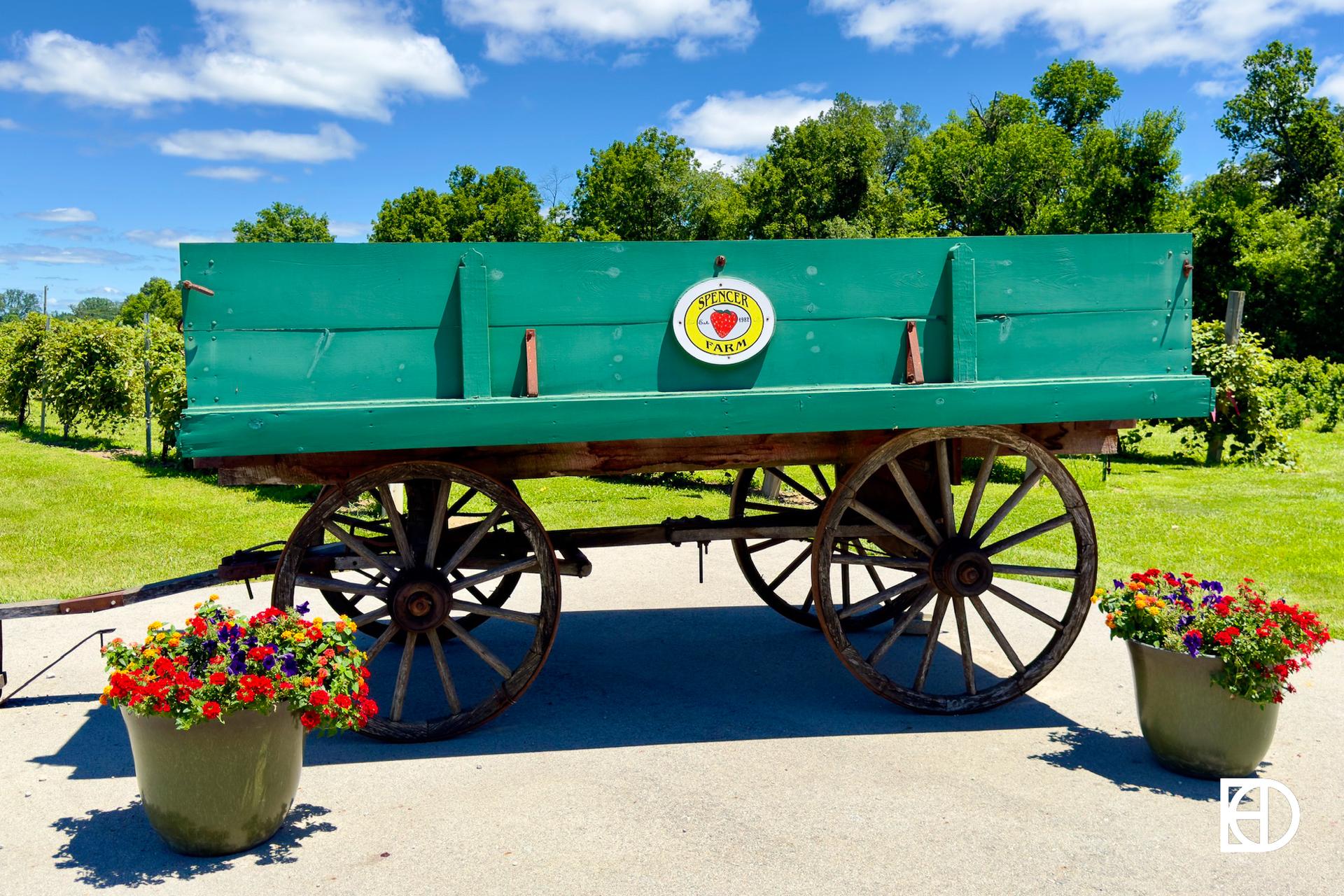 Green hay wagon on display at Spencer Farm