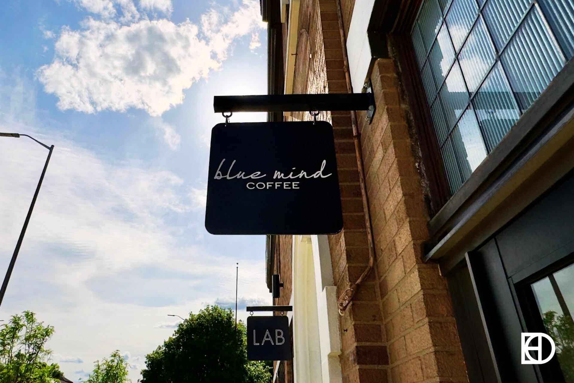 Exterior photo of Blue Mind Coffee, showing signage