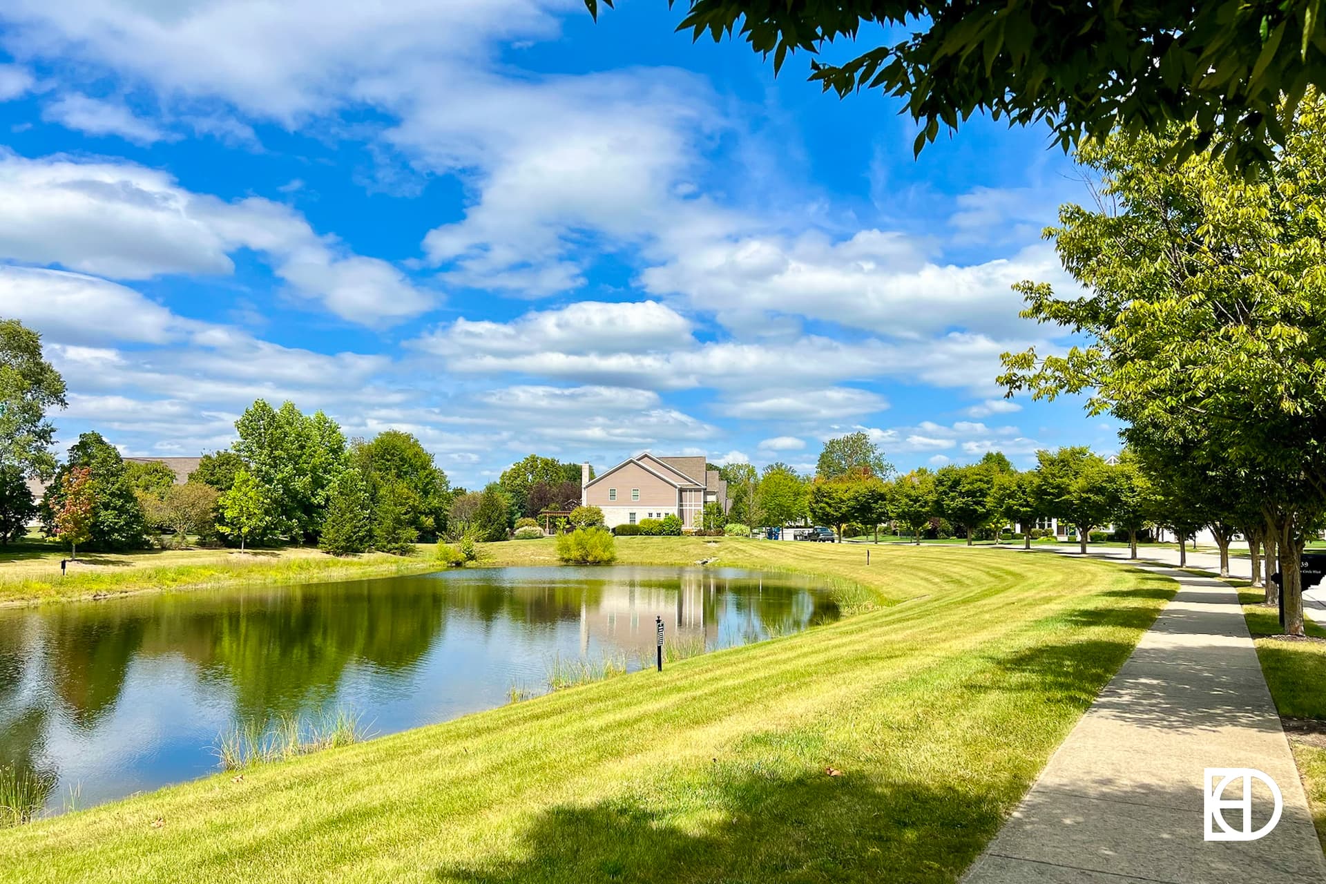 Exterior photo of Lincolnshire, showing pond and landscaping