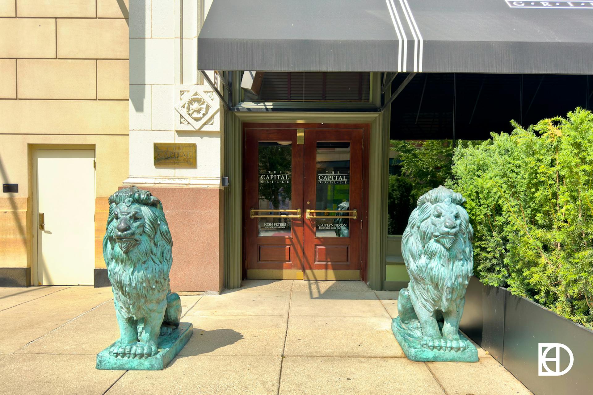 Exterior photo of Capital Grille, showing lion statues and entrance