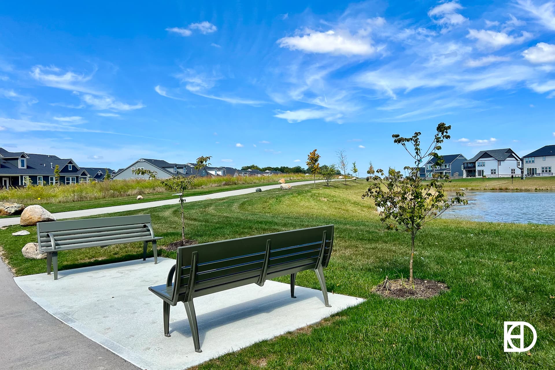 Exterior photo of Albany Village, showing walking paths, benches, and homes