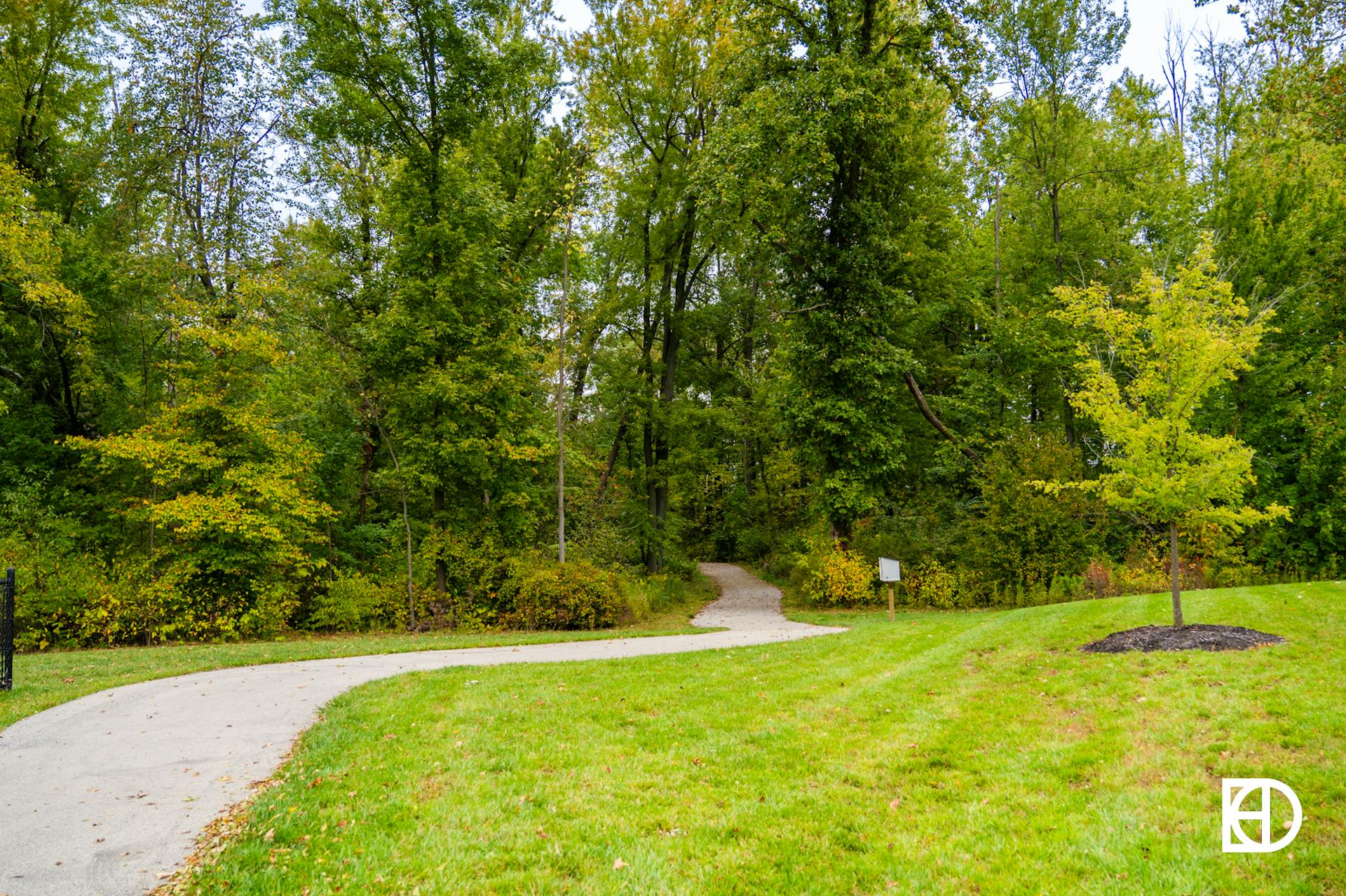 Photo of walking path into woods in Hampshire neighborhood in Zionsville, Indiana.