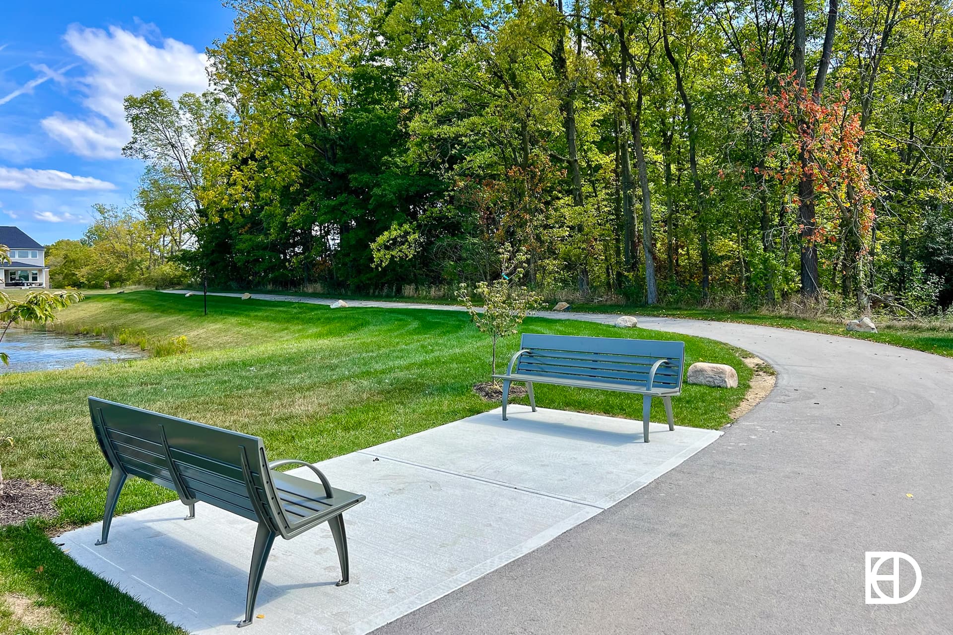 Exterior photo of Albany Village, showing walking trails and benches