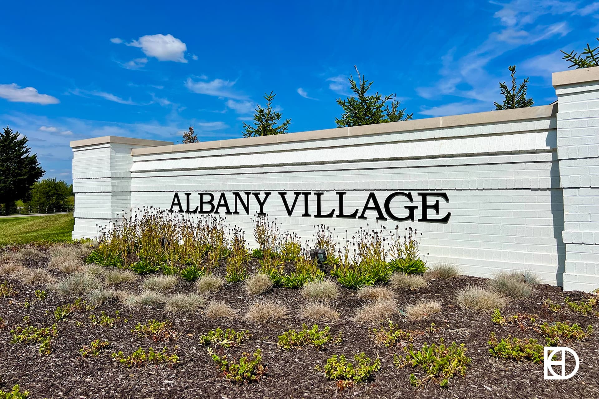 Exterior photo of Albany Village, showing signage