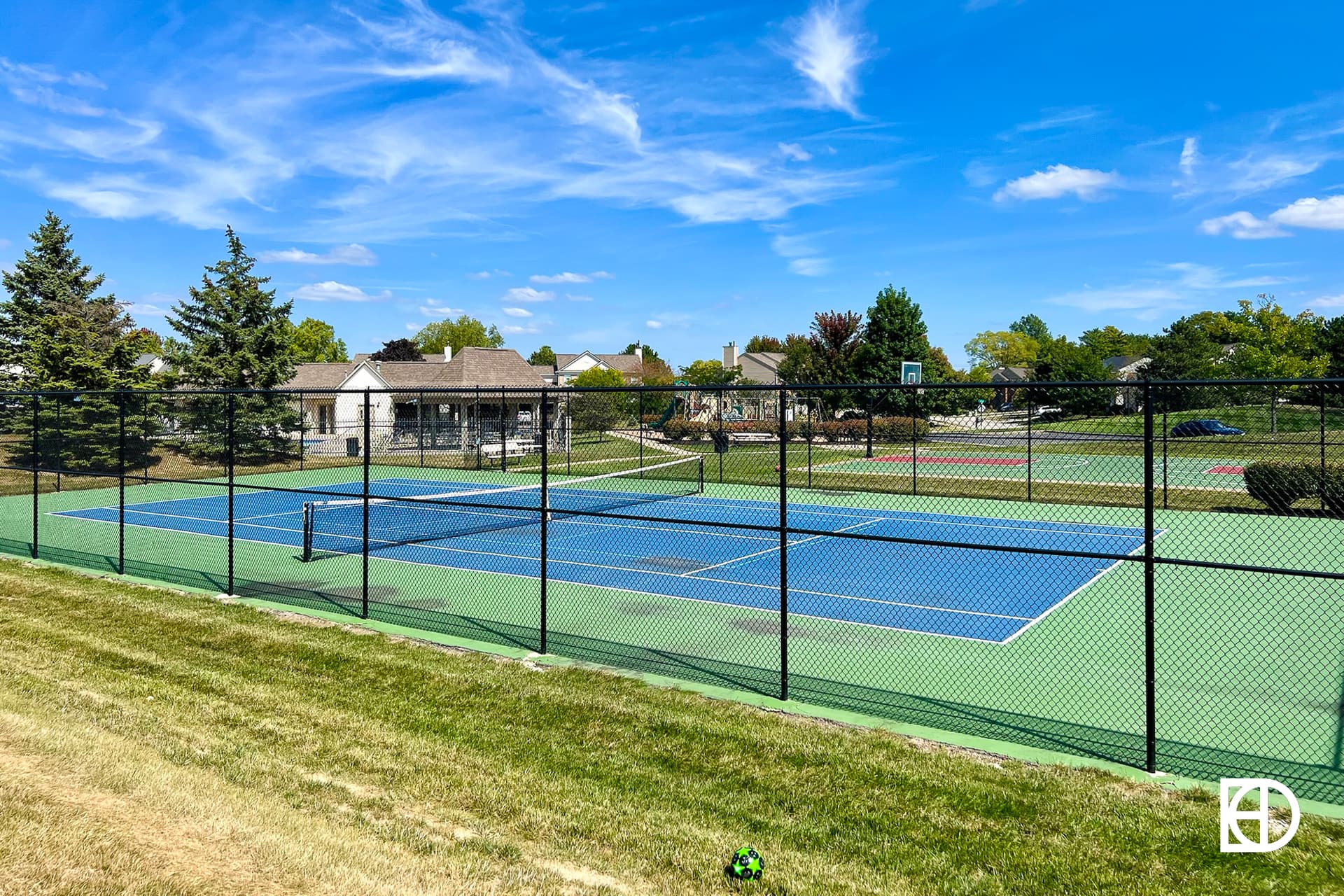 Exterior photo of Saddle Creek, showing tennis courts