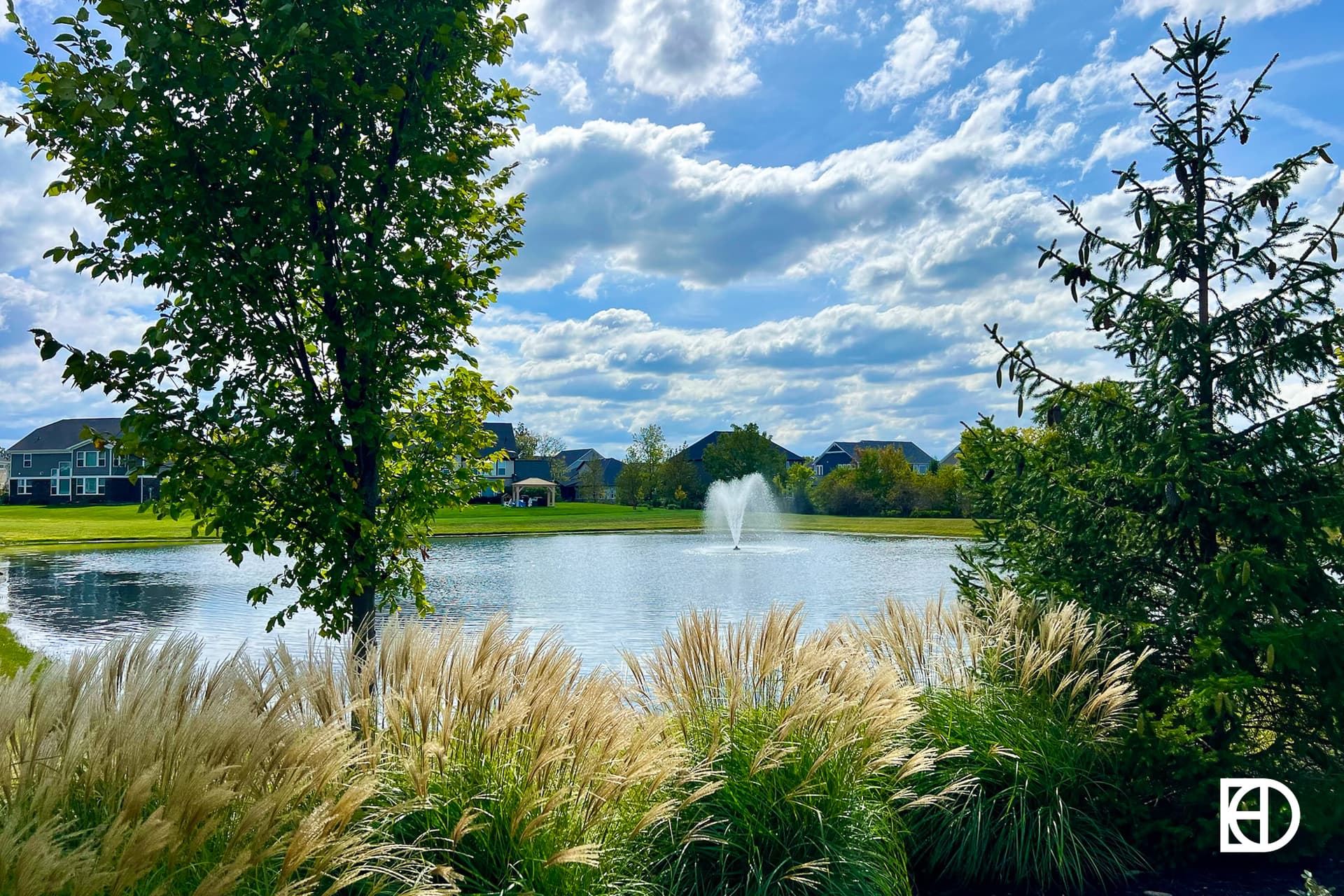 Exterior photo of Tallyn's Ridge, showing pond and landscaping