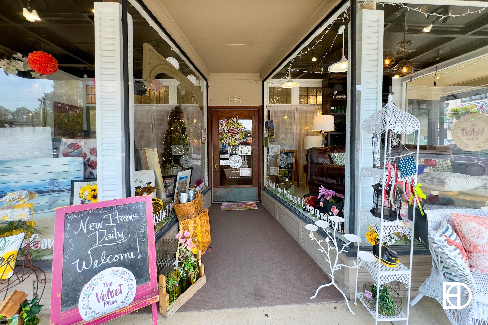 Exterior photo of Velvet Plum, showing signage, entrance, and welcome sign