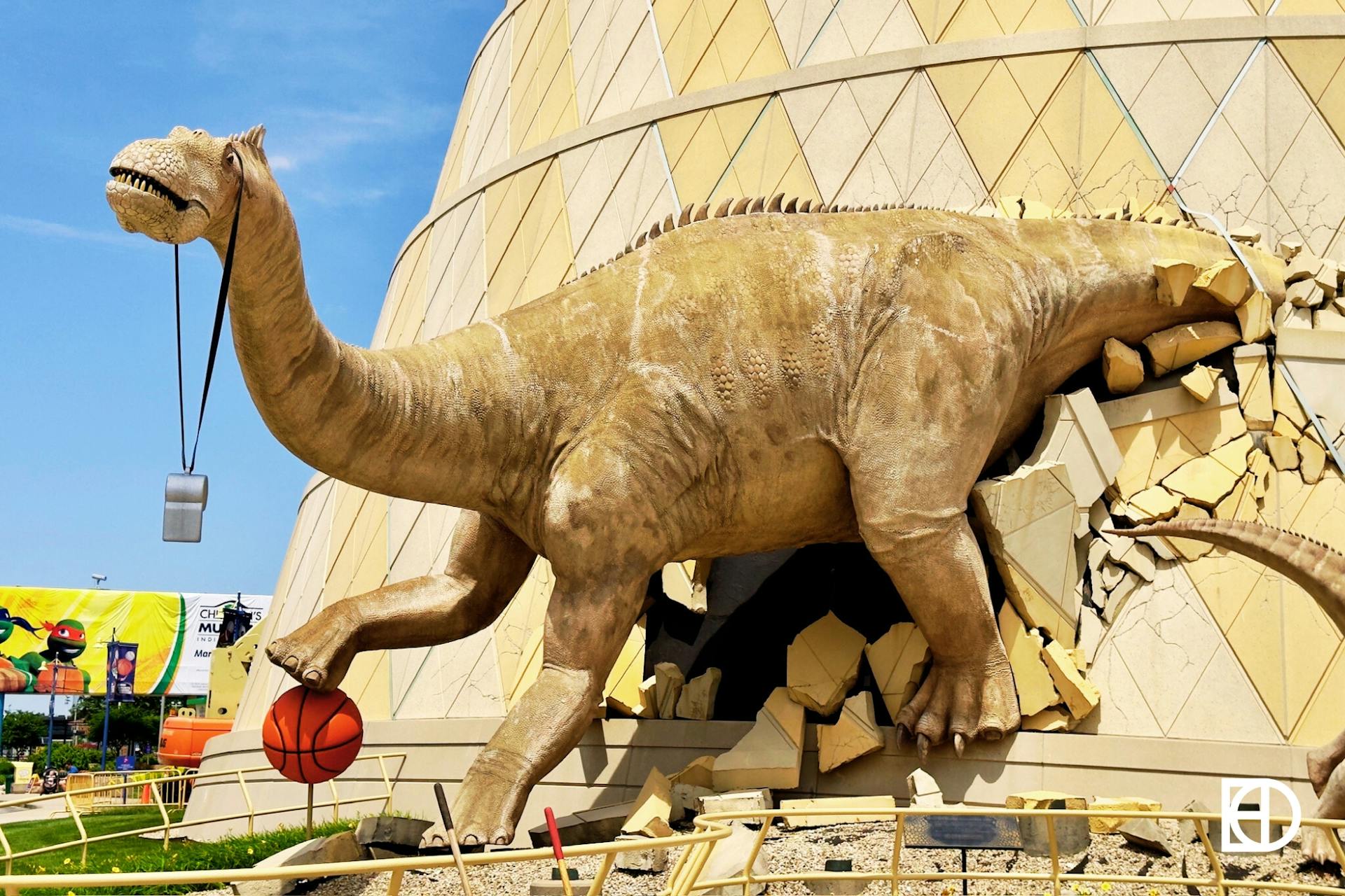 Exterior photo of the Childrens Museum, showing dinosaur statue