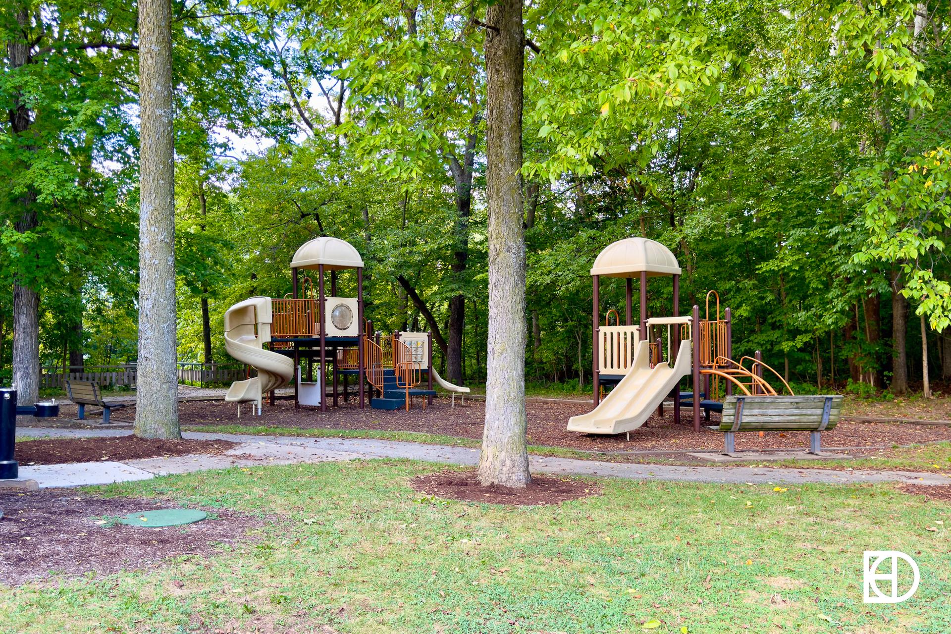 Exterior photo of Potter's Bridge Park, showing landscaping and playground