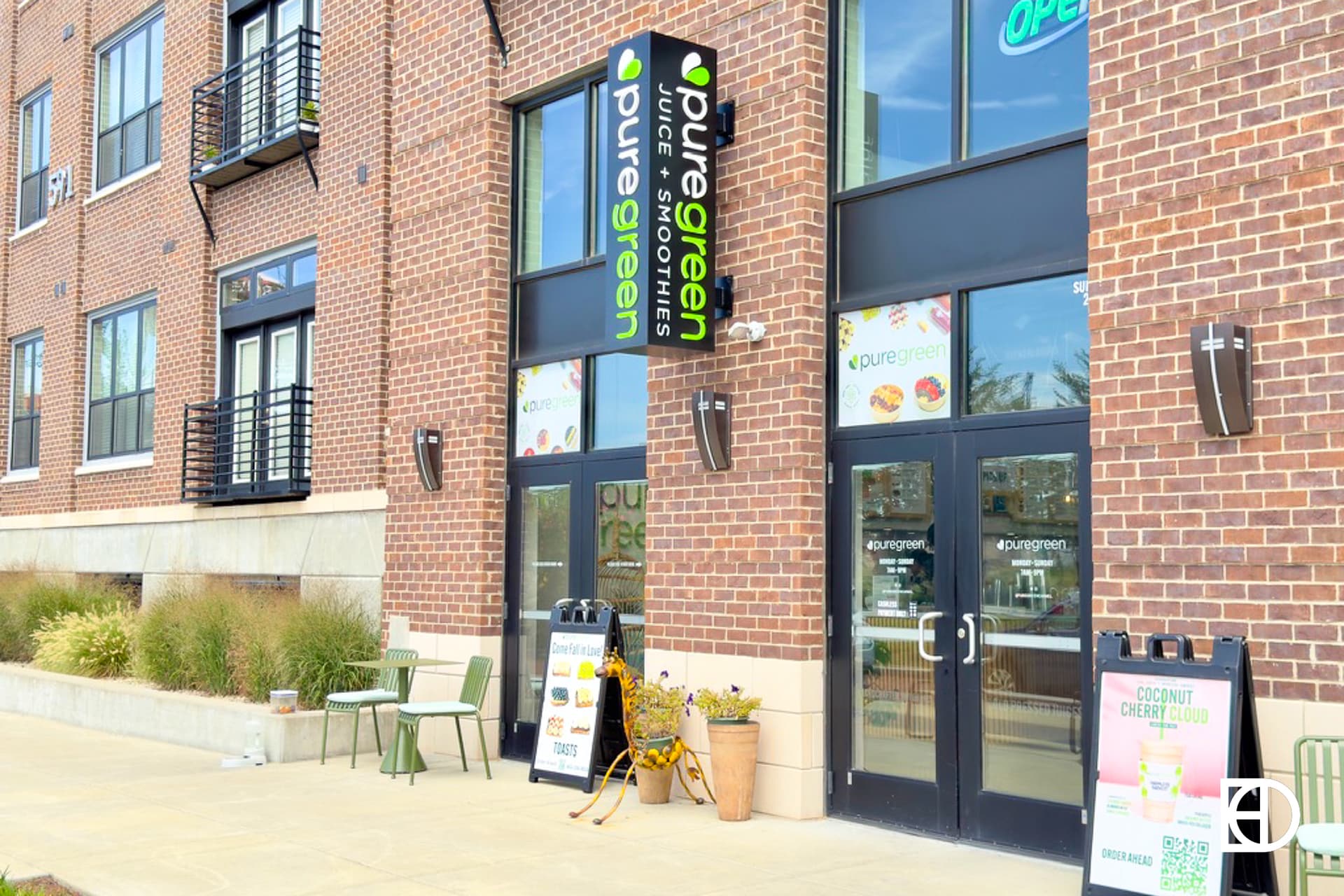 Exterior photo of Pure Green Carmel, showing entrance, signage, and decorative statue