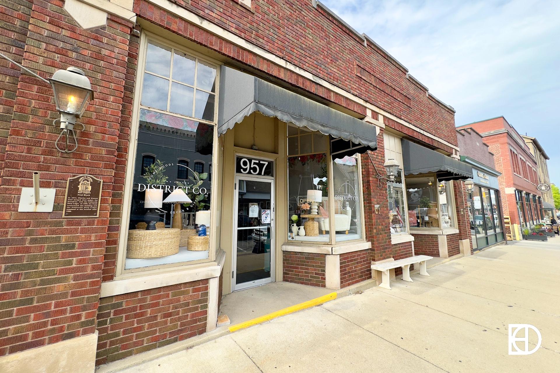 Exterior photo of Two Chicks District Co., showing entrance and signage