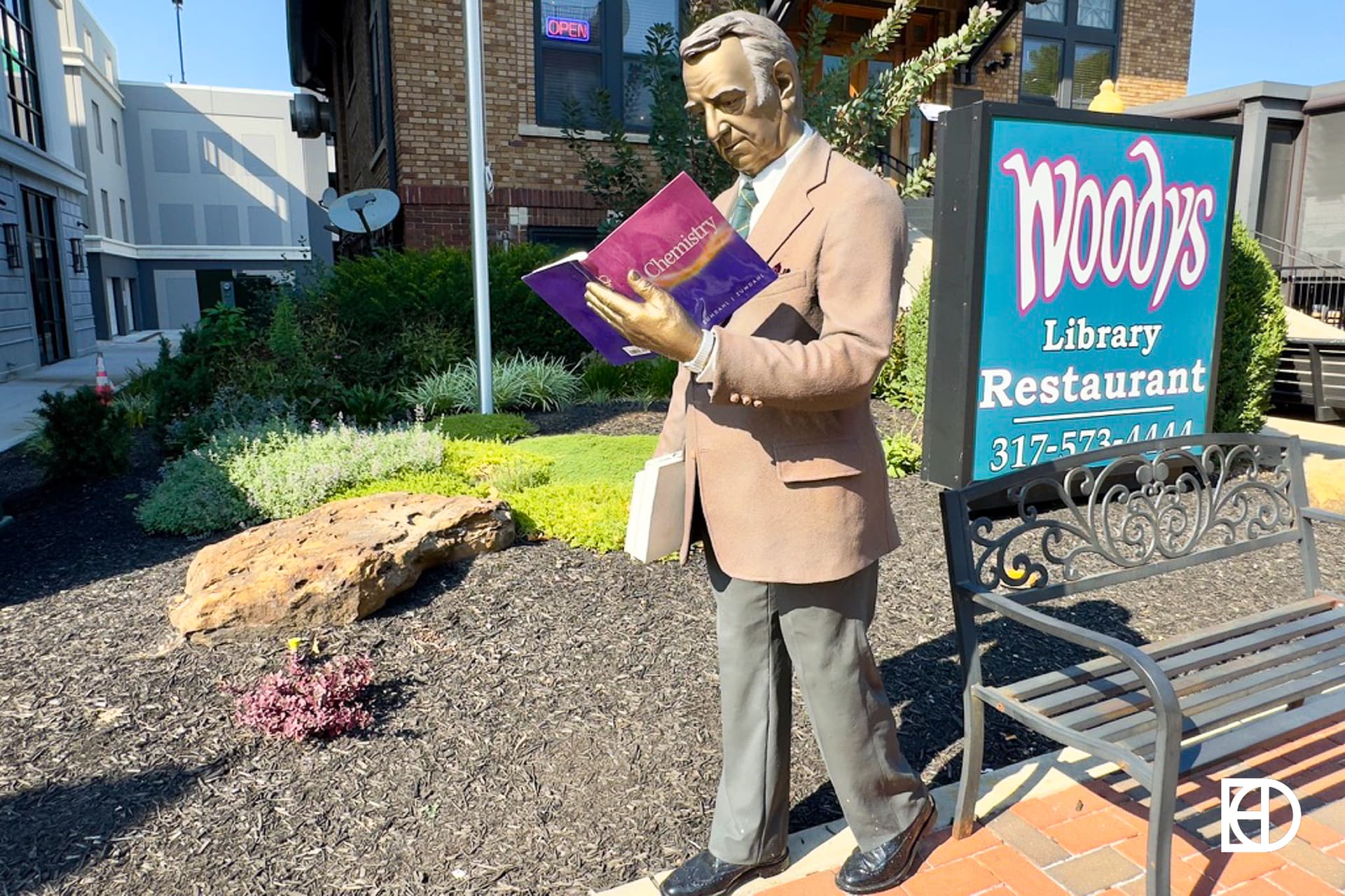 Exterior photo of Woody's, showing statue