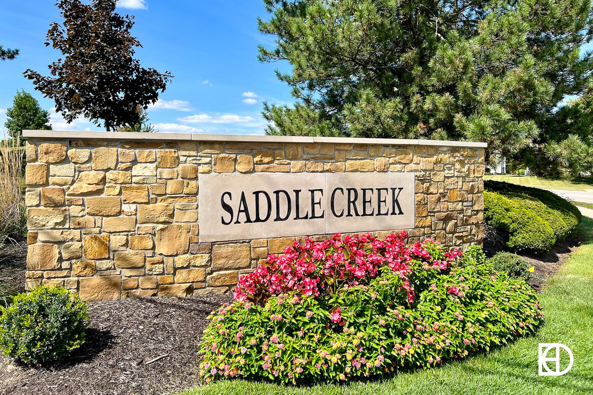 Exterior photo of Saddle Creek, showing signage and landscaping