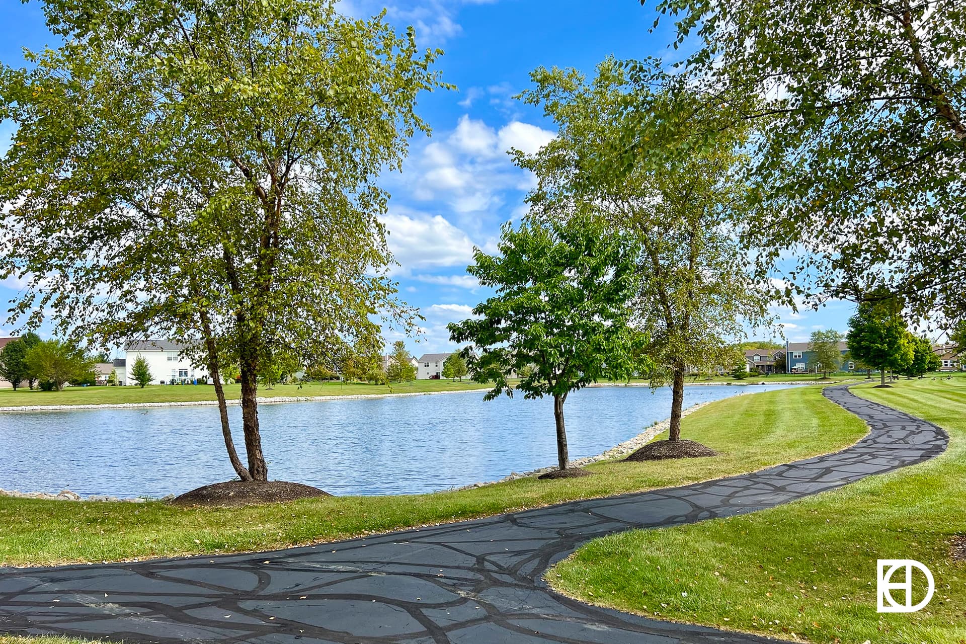 Exterior photo of The Trails at Hayden Run, showing pond and landscaping