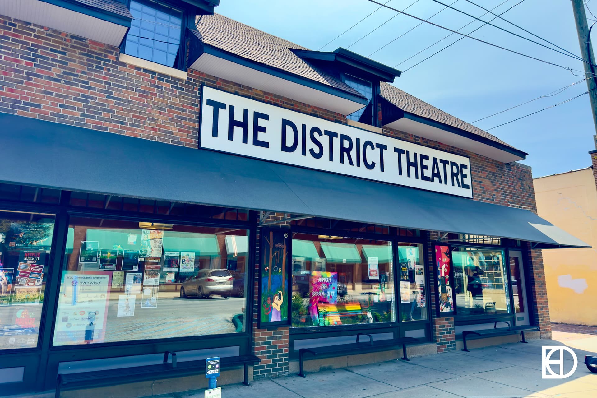 Exterior photo of The District Theatre, showing signage and entrance