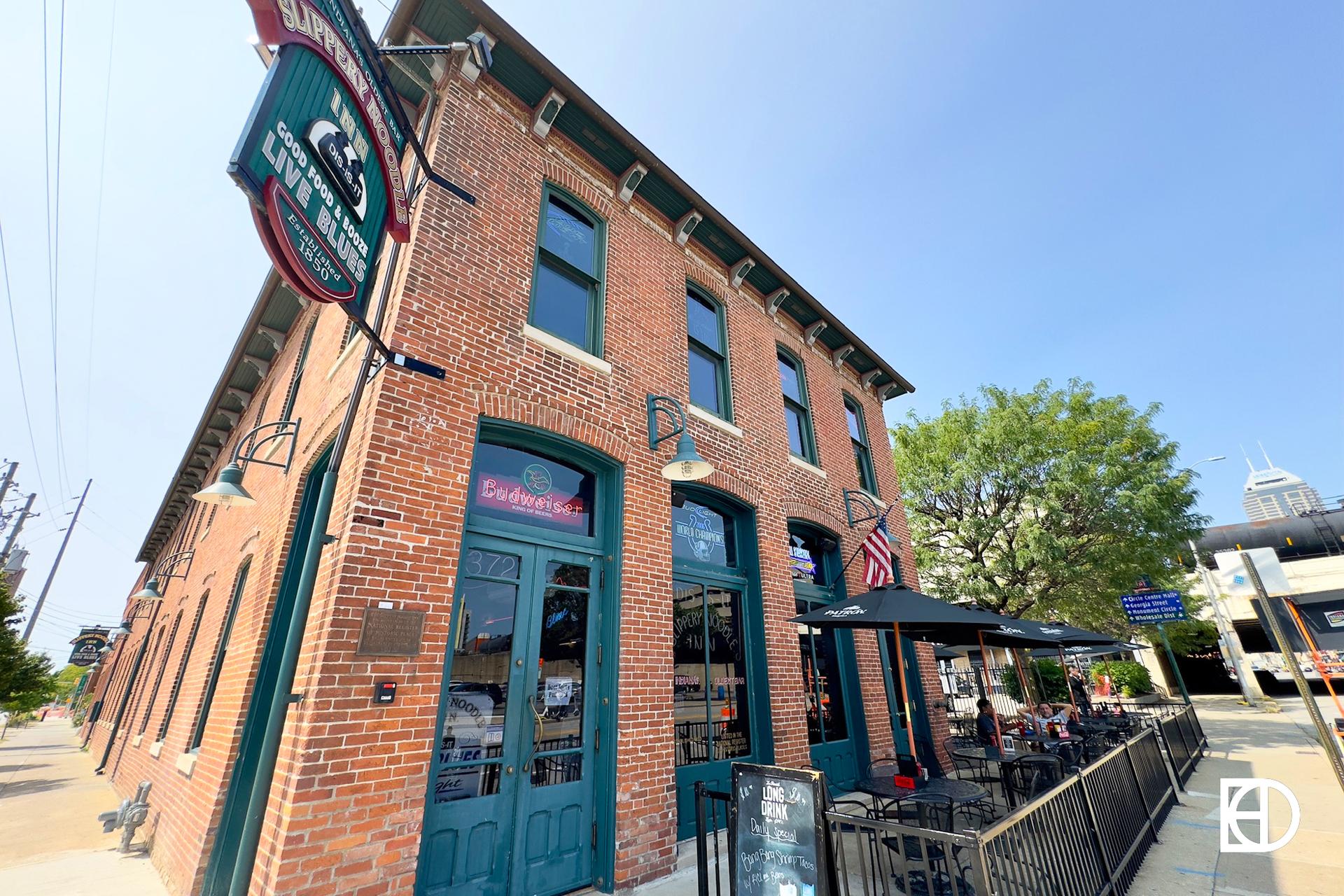 Exterior photo of Slippery Noodle Inn, showing signage, patio, and entrance