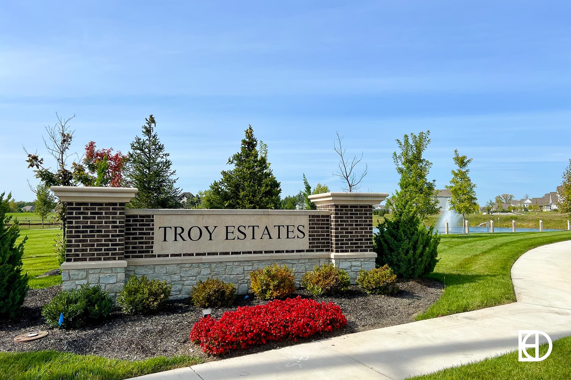 Exterior photo of Troy Estates, showing signage and landscaping