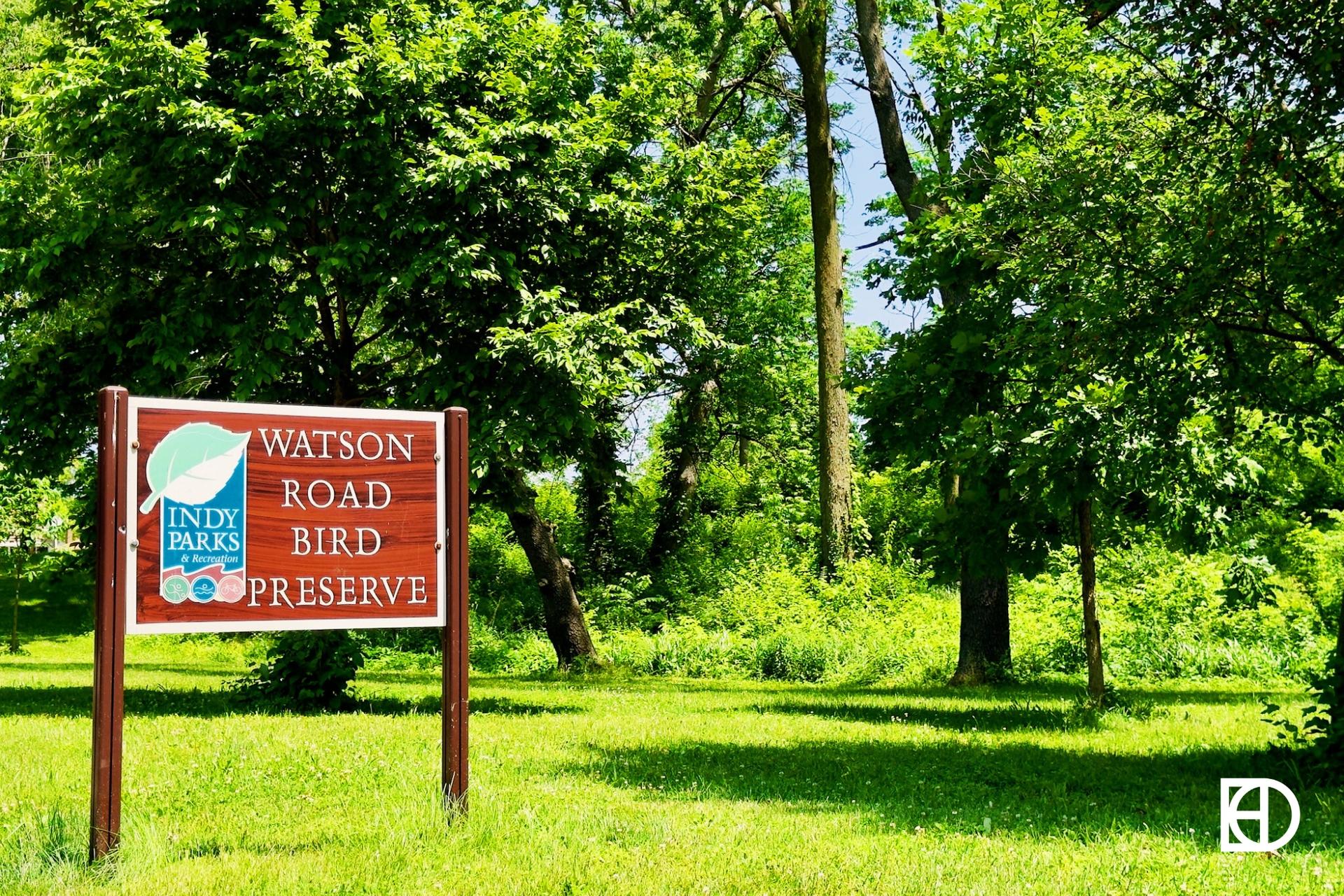 Photo of Watson Road Bird Preserve, showing signage, green space, and trees